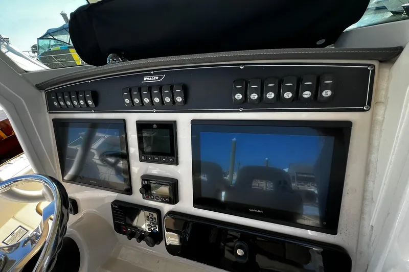 Slide: The Image of Control panel of 2022 Boston Whaler 280 Outrage with Garmin displays and switches. - 9