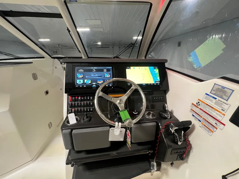 Slide: The Image of 2026 Pursuit DC 365 Dual Console boat dashboard with modern navigation and control systems. - 12