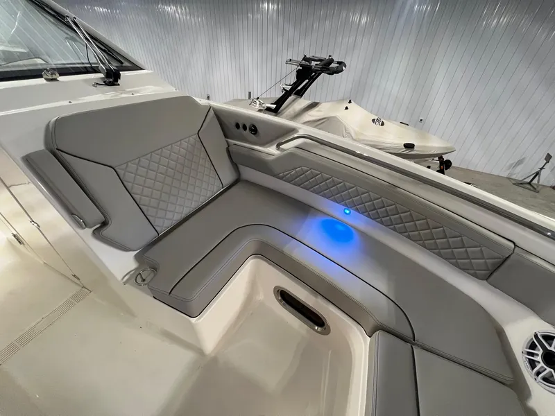 Slide: The Image of Luxurious seating on 2026 Pursuit DC 365 Dual Console boat with blue LED lighting. - 15