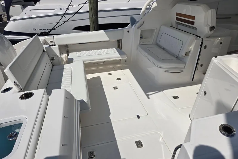 Slide: The Image of Spacious interior of 2026 Pursuit DC 365 Dual Console boat with white seating and sleek design. - 17