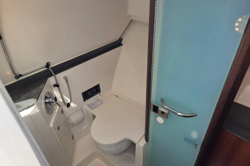 Slide: The Image of 2026 Pursuit DC 365 Dual Console boat bathroom interior with modern fixtures and sleek design. - 22