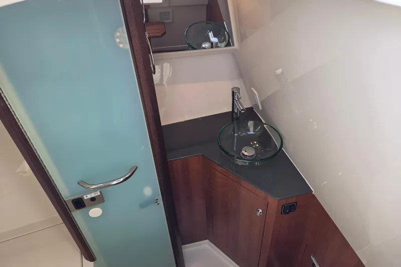 Slide: The Image of 2026 Pursuit DC 365 Dual Console bathroom with modern glass sink and sleek design. - 23