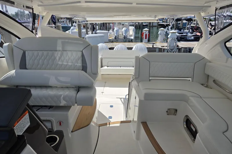 Slide: The Image of Interior of 2026 Pursuit DC 365 Dual Console boat with luxurious seating and modern design. - 24