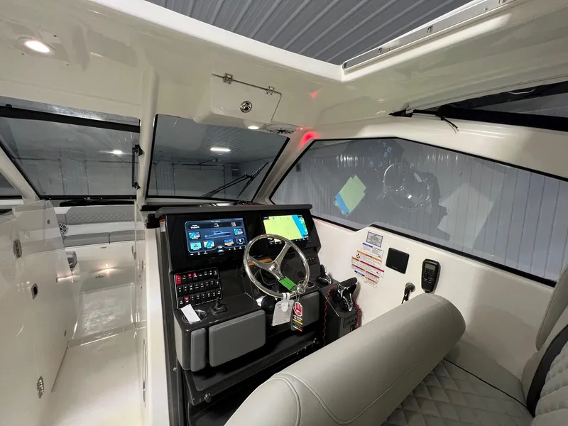 Slide: The Image of 2026 Pursuit DC 365 Dual Console boat interior with modern dashboard and steering wheel. - 5