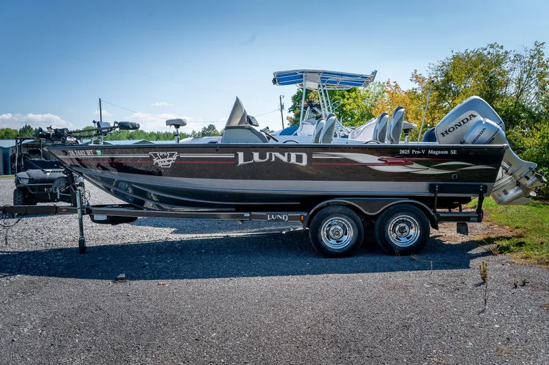 Slide: The Image of 2006 Lund 2025 Pro-V Magnum SE boat on trailer with Honda outboard motor. - 2