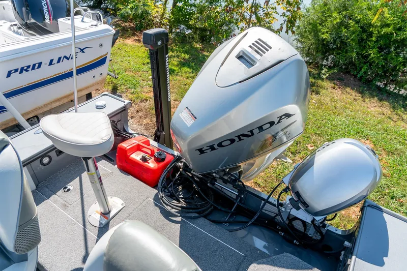 Slide: The Image of 2006 Lund 2025 Pro-V Magnum SE boat with Honda outboard motor and fishing seat. - 27