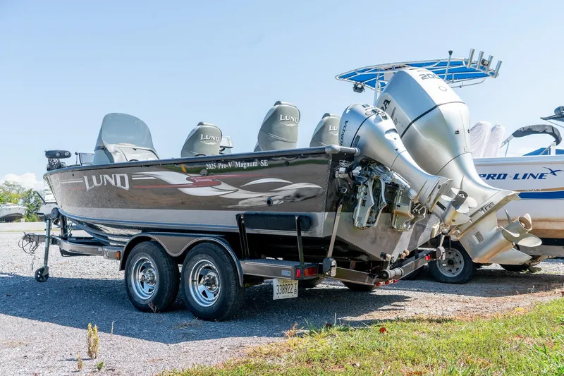 Slide: The Image of 2006 Lund 2025 Pro-V Magnum SE boat on trailer with dual outboard motors. - 3