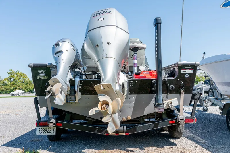 Slide: The Image of 2006 Lund 2025 Pro-V Magnum SE boat with dual outboard motors on trailer. - 7