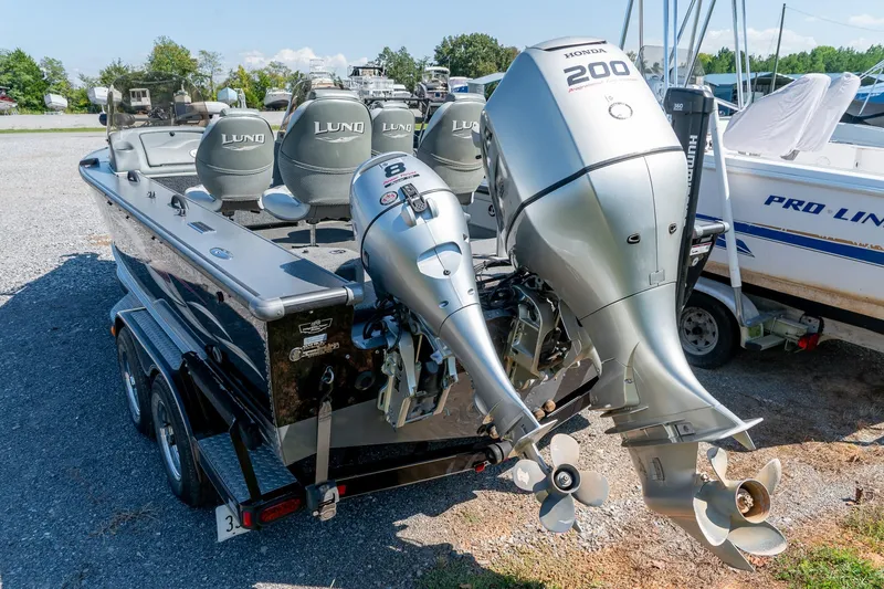 Slide: The Image of 2006 Lund 2025 Pro-V Magnum SE boat with dual outboard motors in a marina setting. - 8