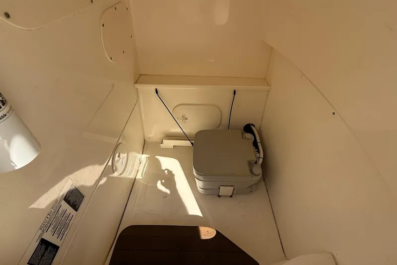 Slide: The Image of Interior of 2017 Boston Whaler 270 Dauntless boat with portable toilet. - 13