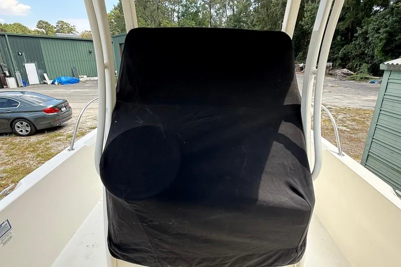 Slide: The Image of 2017 Boston Whaler 270 Dauntless boat with covered console, parked outdoors. - 16