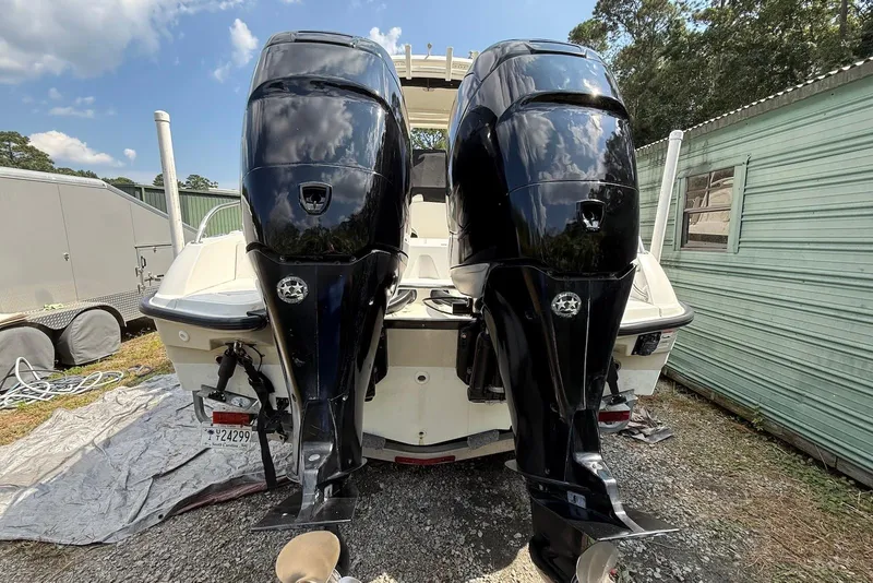Slide: The Image of 2017 Boston Whaler 270 Dauntless with dual outboard engines, parked outdoors. - 17