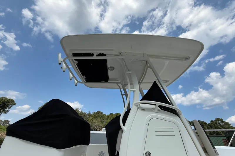 Slide: The Image of 2017 Boston Whaler 270 Dauntless boat with T-top under a partly cloudy sky. - 18