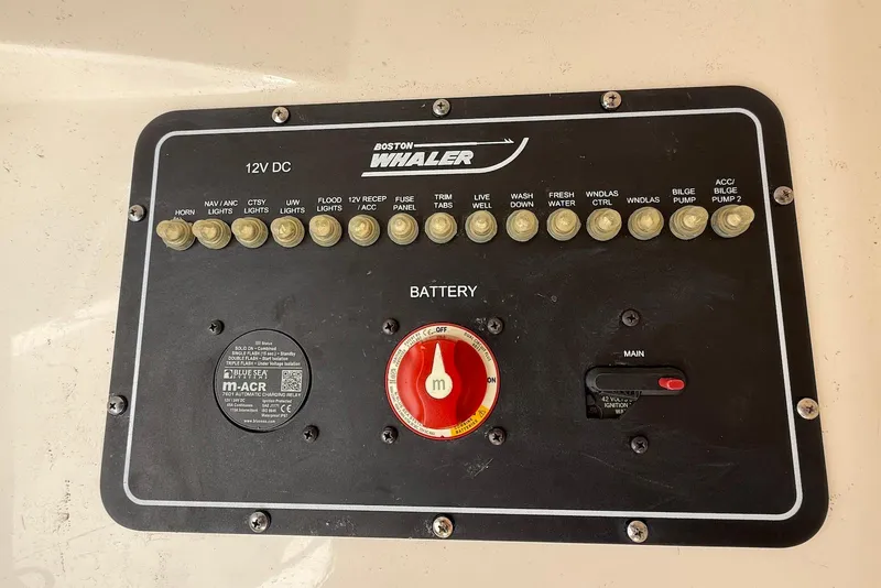 Slide: The Image of Control panel of a 2017 Boston Whaler 270 Dauntless boat with various switches. - 19