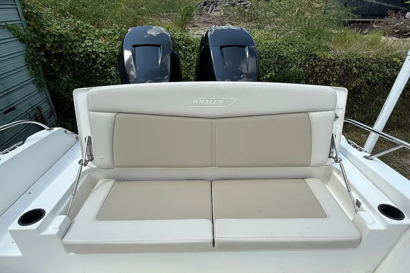 Slide: The Image of 2017 Boston Whaler 270 Dauntless boat seating with dual engines in the background. - 3
