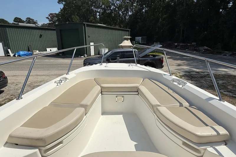 Slide: The Image of 2017 Boston Whaler 270 Dauntless boat with beige seating, parked outdoors. - 4