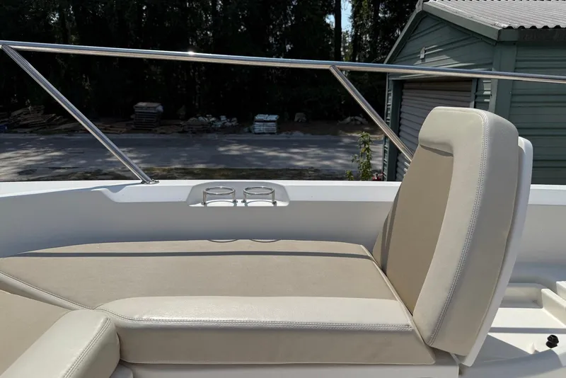 Slide: The Image of 2017 Boston Whaler 270 Dauntless boat seating area with cup holders and railing. - 5