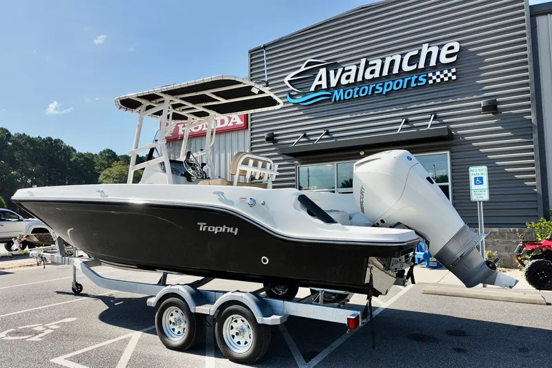 The Image of 2026 Bayliner Trophy T22CC boat on trailer at Avalanche Motorsports dealership. - 1