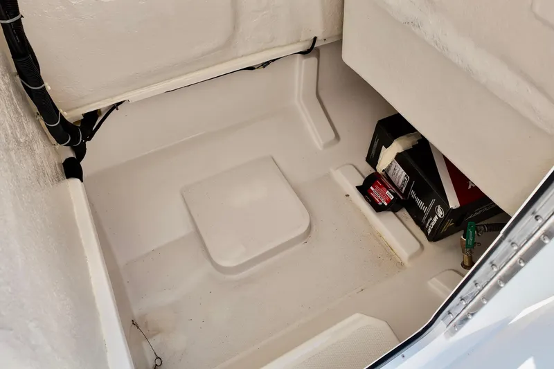 Slide: The Image of Storage compartment of 2026 Bayliner Trophy T22CC boat, featuring clean interior and equipment. - 15