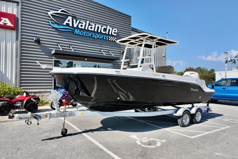 Slide: The Image of 2026 Bayliner Trophy T22CC boat on trailer at Avalanche Motorsports dealership. - 2
