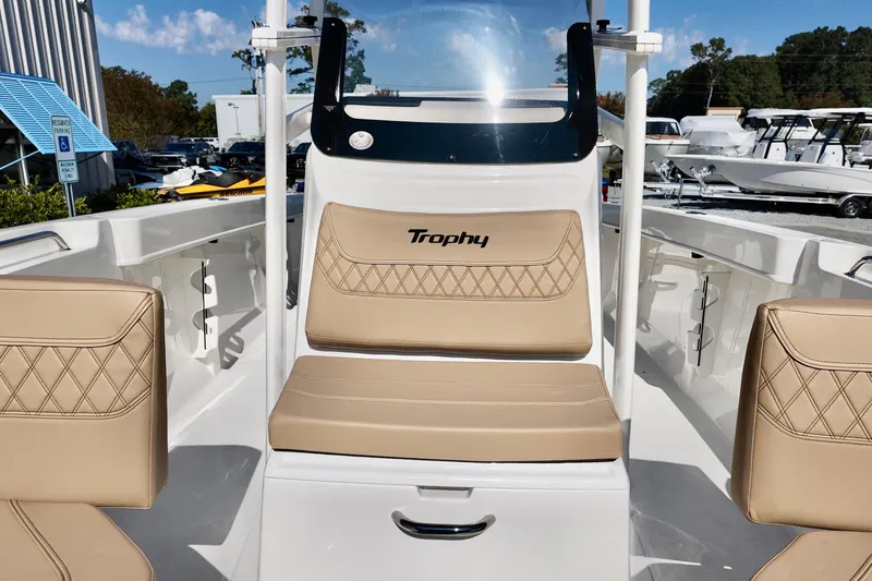 Slide: The Image of 2026 Bayliner Trophy T22CC boat interior with beige seating and console. - 6