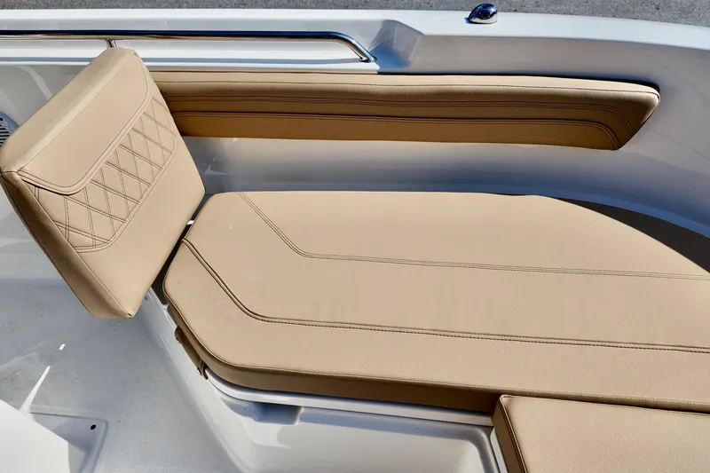 Slide: The Image of 2026 Bayliner Trophy T22CC boat with beige cushioned seating and sleek design. - 7