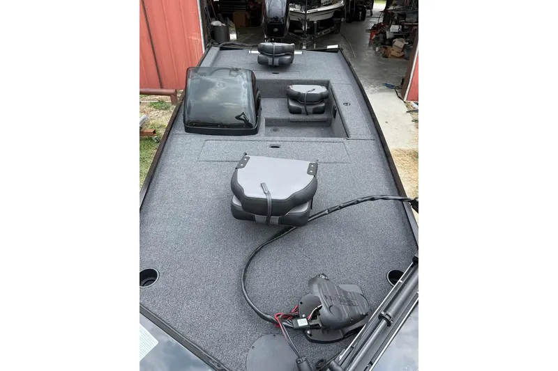 Slide: The Image of 2026 Lowe Skorpion 16 boat interior with seating and equipment, parked in a garage. - 2