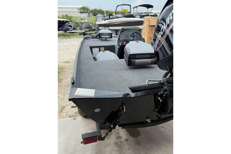 Slide: The Image of 2026 Lowe Skorpion 16 boat with Mercury engine, parked outdoors on a trailer. - 3