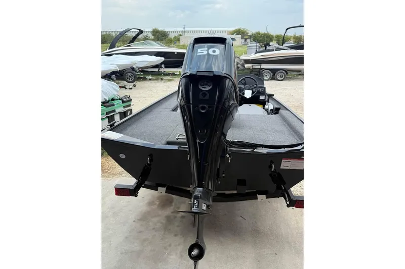 Slide: The Image of 2026 Lowe Skorpion 16 boat with a powerful outboard motor, parked outdoors. - 5