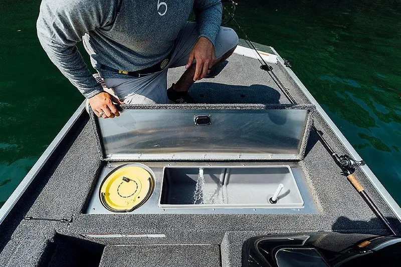 Slide: The Image of Manufacturer Provided Image: Man inspecting livewell on 2026 Lowe Skorpion 16 fishing boat. - 9