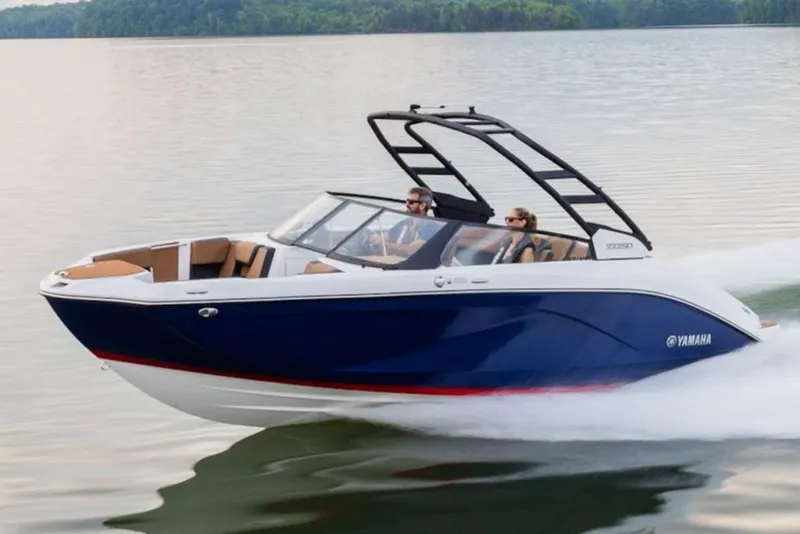 Slide: The Image of 2026 Yamaha Boats 222SE cruising on a serene lake with passengers. - 0