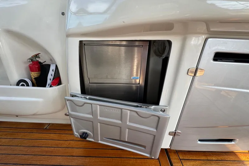 Slide: The Image of Cranchi Mediterranee 43 yacht interior, featuring a built-in ice maker and fire extinguisher, 2009 model. - 18