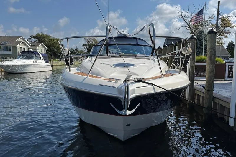 Slide: The Image of 2009 Cranchi Mediterranee 43 yacht docked in a marina, clear sky background. - 2