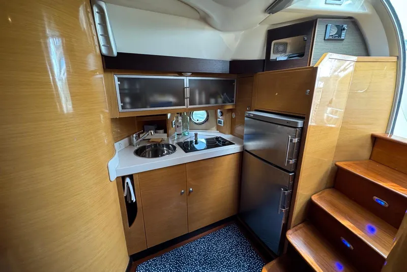 Slide: The Image of Luxurious 2009 Cranchi Mediterranee 43 yacht kitchen with modern appliances and wooden cabinetry. - 27