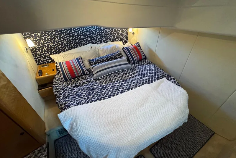 Slide: The Image of Luxurious bedroom interior of 2009 Cranchi Mediterranee 43 yacht with patterned bedding and pillows. - 29