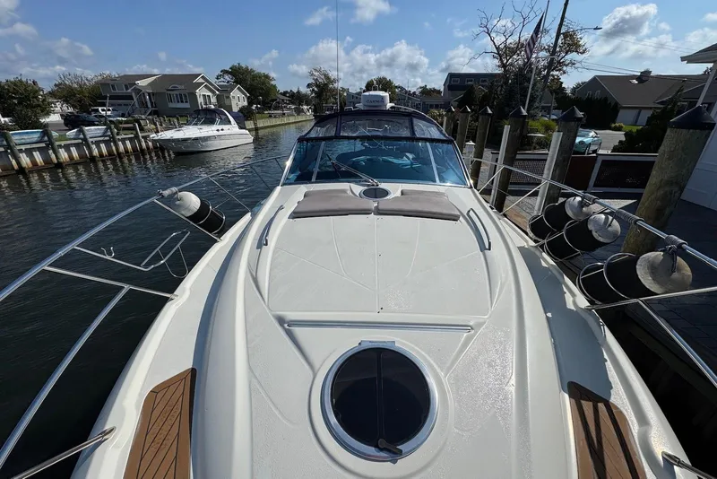 Slide: The Image of 2009 Cranchi Mediterranee 43 yacht docked in a scenic marina setting. - 3