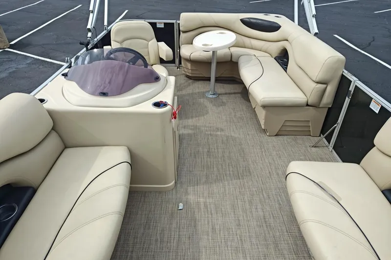 Slide: The Image of 2019 Sylvan 818 Mirage Cruise boat interior with beige seating and table. - 4
