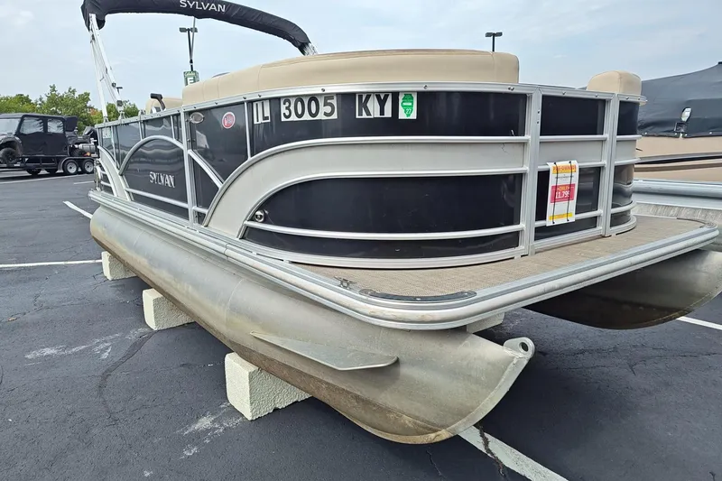 Slide: The Image of 2019 Sylvan 818 Mirage Cruise pontoon boat on display in a parking lot. - 6