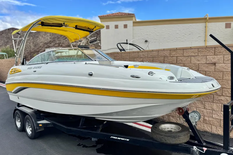 Slide: The Image of 2005 MB 240 V Sportdeck boat with yellow accents on a trailer. - 1