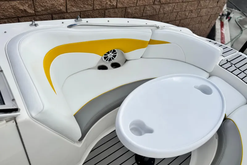 Slide: The Image of 2005 MB 240 V Sportdeck boat interior with white and yellow seating, round table. - 10