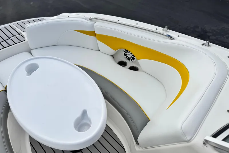 Slide: The Image of 2005 MB 240 V Sportdeck boat interior with white and yellow seating, oval table. - 11