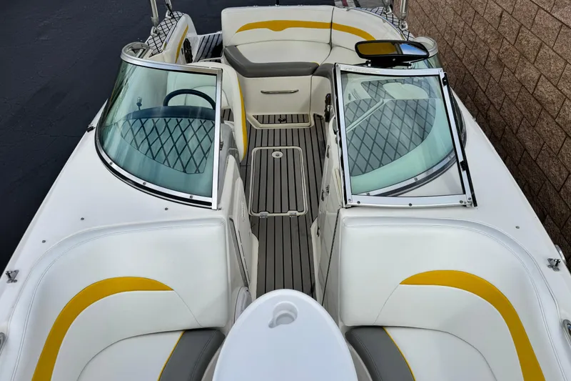 Slide: The Image of 2005 MB 240 V Sportdeck boat interior with white and yellow seating, open windshield. - 14