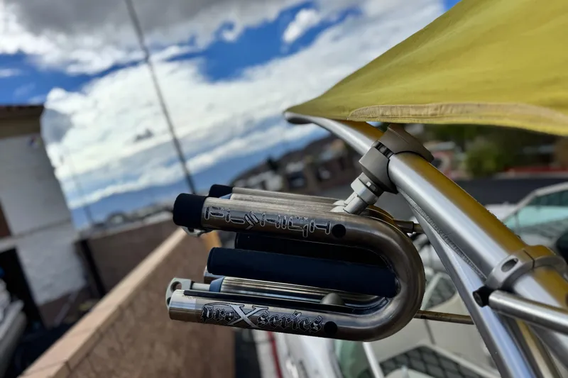 Slide: The Image of 2005 MB 240 V Sportdeck boat with yellow canopy and metal fittings under cloudy sky. - 17