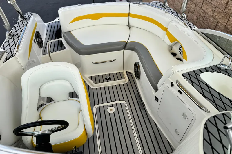 Slide: The Image of 2005 MB 240 V Sportdeck boat interior with white and yellow seating, steering wheel, and speakers. - 19