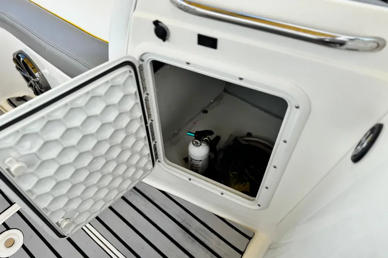 Slide: The Image of Open storage compartment on 2005 MB 240 V Sportdeck boat with fire extinguisher inside. - 21