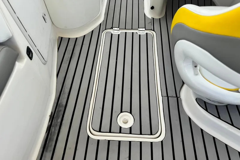 Slide: The Image of 2005 MB 240 V Sportdeck boat interior with gray and white flooring, yellow-accented seat. - 25