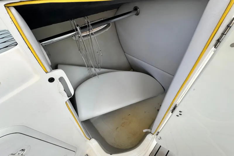 Slide: The Image of 2005 MB 240 V Sportdeck interior storage compartment with metal rod and white padding. - 27