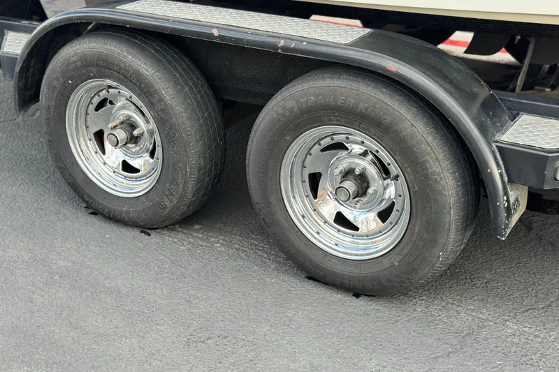 Slide: The Image of 2005 MB 240 V Sportdeck trailer wheels with chrome rims on asphalt surface. - 34