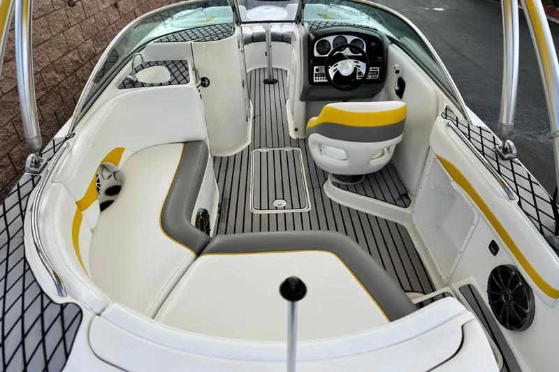 Slide: The Image of 2005 MB 240 V Sportdeck boat interior with white and yellow seating, sleek design. - 8