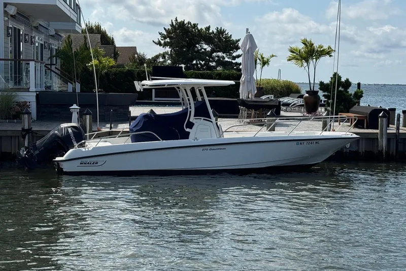 The Image of 2015 Boston Whaler 270 Dauntless boat docked by waterfront home. - 0